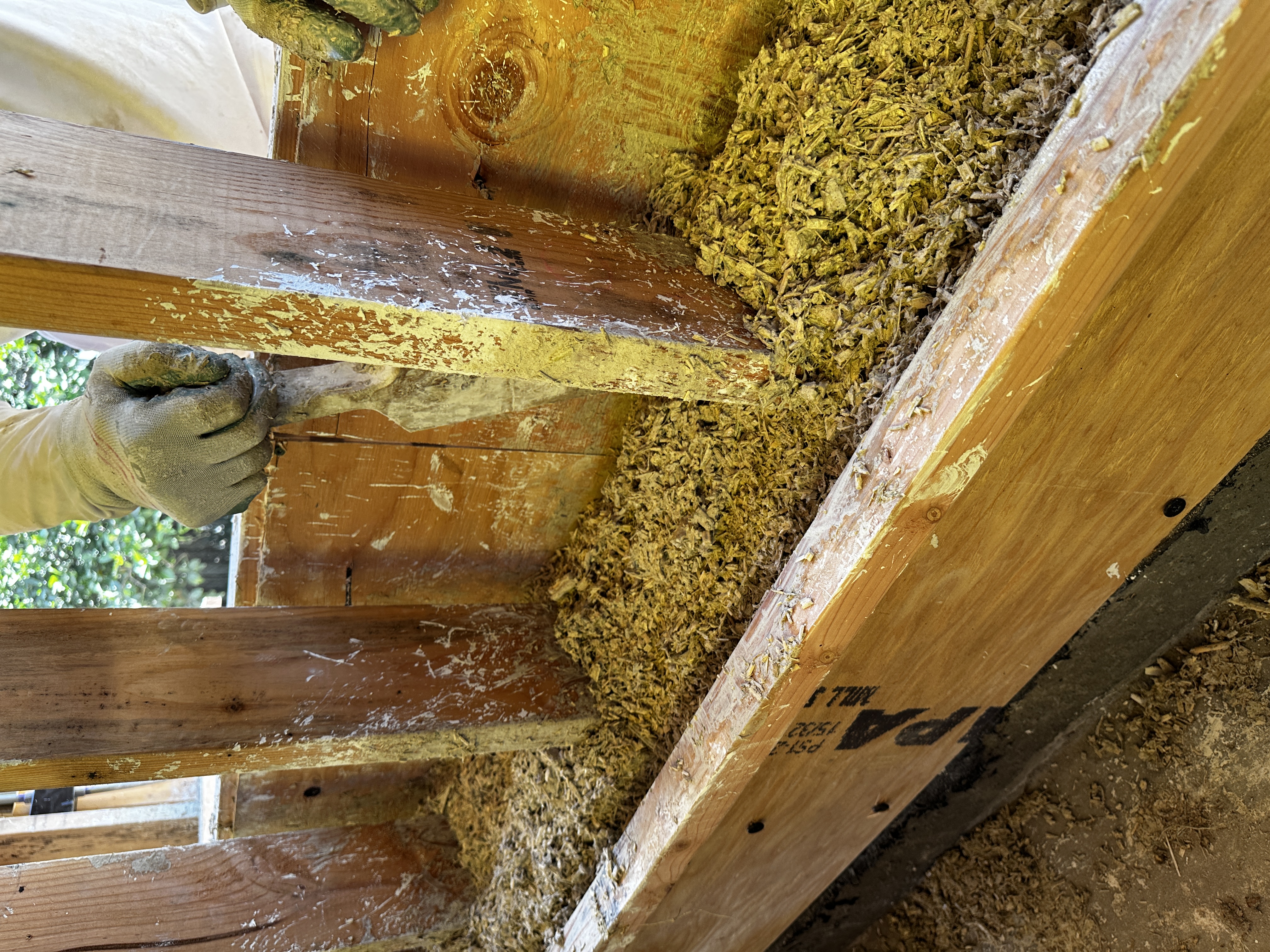 Hempcrete being tamped into wall forms during construction of the Atwater Village ADU